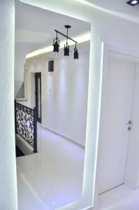 a hallway with a white staircase with a mirror at Uvac lake "FF" in Sjenica