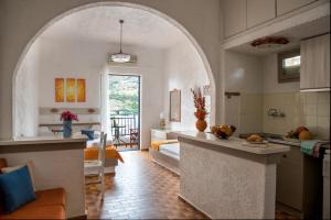 a kitchen with an archway in the middle of a room at Amazona in Agia Pelagia