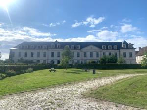 a large white building with a park in front of it at La Visitation - 30 in Orthez