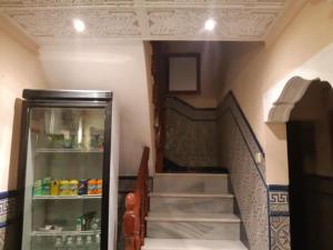 a staircase in a room with a refrigerator next to a staircase at Hostal ALGECIRAS in Algeciras