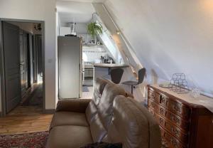 a living room with a couch and a kitchen at La Visitation - 30 in Orthez