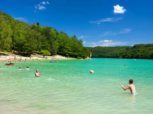 a group of people in the water at a beach at "Le Petit Paradis" au Centre Ville d'Oyonnax in Oyonnax
