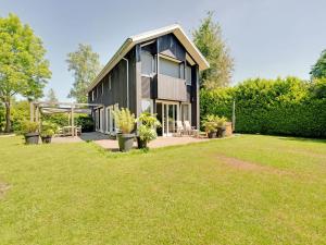 a house with a large yard in front of it at Spacious and stylish family home in Grou in Grou