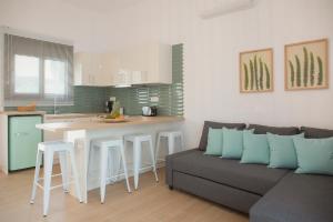 a living room with a couch and a kitchen at Peratzada in Tsilivi
