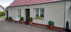 een huis met een raam met een bank en planten bij Holiday home in Bergen auf Rügen 2852 in Bergen auf Rügen