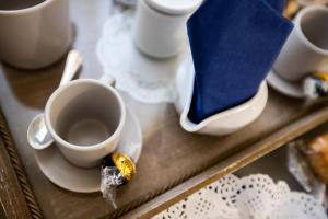 a cup of coffee on a tray with a bird on it at ANFOL in Bari