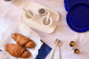 a table with a plate of pastries and a cup of coffee at ANFOL in Bari