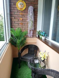 a porch with a glass table and a chair at Apartment Ani in Veliko Tŭrnovo