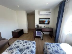 a hotel room with a bed and a desk and a tv at Petra Heart Hotel in Wadi Musa