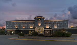 a large building with a clock on the front of it at Prestige Treasure Cove Resort, WorldHotels Elite in Prince George