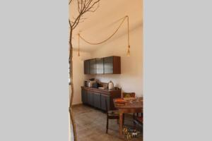 a kitchen with a table and a dining room at Gosto do Campo in Lavre