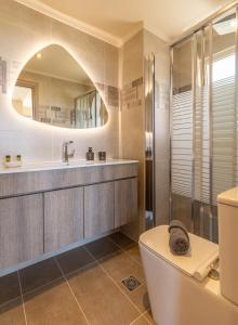 a bathroom with a shower and a toilet and a sink at Cretan fleur apartments in Elafonisi