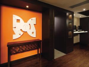 an orange wall with a large k sign on it at Butterfly on Wellington, Central in Hong Kong