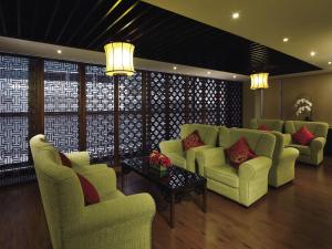 a living room with couches and a table and chairs at Butterfly on Wellington, Central in Hong Kong