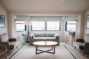 a living room with a couch and chairs and a table at Gurney's Montauk Resort & Seawater Spa in Montauk