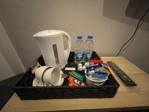 a basket on a table with water bottles and food at Westend Holiday Room 1 Brecon - Shared Bathroom in Brecon