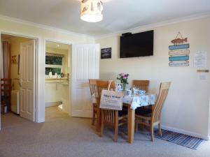 a dining room with a table with a sign on it at Stones Throw in Saint Mawes