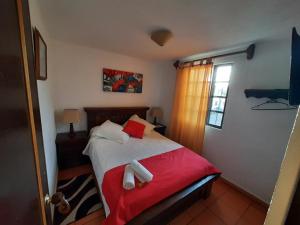 Katil atau katil-katil dalam bilik di Aparta Hotel El Refugio de María
