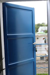 a blue door in front of a window at La porte bleue in Baie-Mahault