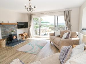 a living room with a couch and a fireplace at Y Stabl in Llanrwst