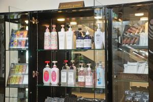 a shelf filled with lots of bottles of alcohol at Hotel Grandolce HAKATA in Fukuoka +16 photos