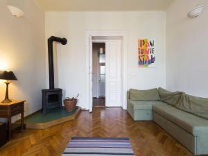 a living room with a couch and a stove at Stanislas Apartment in Krakow
