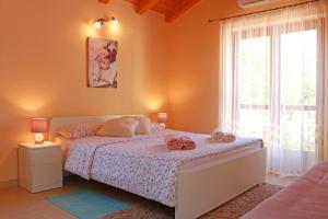 a bedroom with a bed and a large window at Studio Apartment Volta in Crveni Vrh