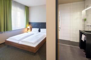 Voodi või voodid majutusasutuse JOESEPP´S HOTEL am Hallhof toas