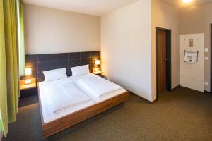 Voodi või voodid majutusasutuse JOESEPP´S HOTEL am Hallhof toas