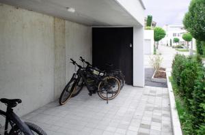 two bikes parked next to a building with a door at seelandsuite Bodensee in Bermatingen