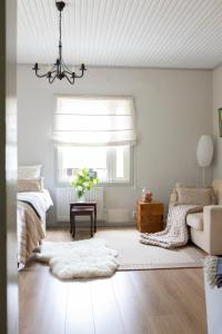 a living room with a bed and a window at Karkausmäen Kammari in Kinnula