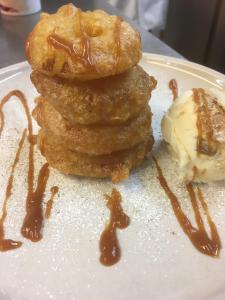 a stack of donuts and ice cream on a plate at The Fleece Inn in Bishop Wilton