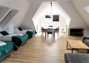 a room with beds and a dining room with a table at Hotel KAVKA & Restauracja in Czersk Pomorski