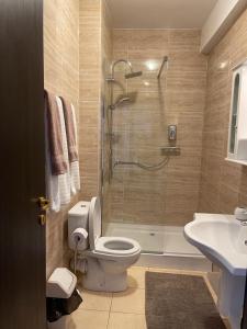 a bathroom with a shower and a toilet and a sink at Perfect Spot Summerland Mamaia in Mamaia