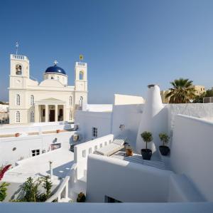 a view of a white building with stairs and plants at Betty's Home Santorini in Karterados