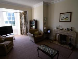 a living room with a couch and a fireplace at Newmill Farm in Stanley