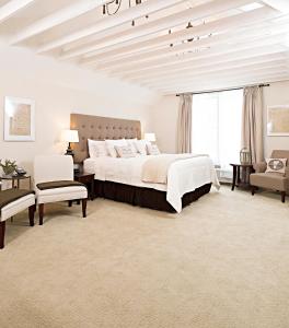 a bedroom with a large bed and a large window at On the River Inn in Woodstock