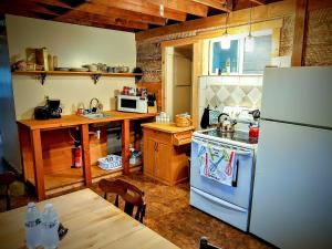 a kitchen with a white refrigerator and a table at Three Bears Inn in Saint Anthony