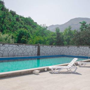 a swimming pool with a chair and avisorvisor at Spitak Tun in Ijevan