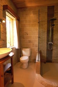 a bathroom with a toilet and a sink and a shower at Akasha Beach Club in Bulukumba