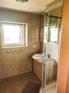 a bathroom with a shower and a sink at Apartamenty Termy The Best Bańska in Szaflary