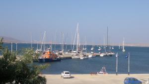 a harbor filled with lots of boats on a sunny day at To Kyma in Moúdhros