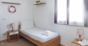 A bed or beds in a room at Domo Galante
