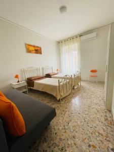 a large bedroom with two beds and a window at Sassi Planet in Matera