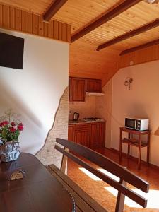 a kitchen with a wooden bench in a room at Приватна Садиба Потічок in Slavske