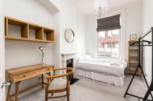 a bedroom with a desk and a bed and a window at Bright & Spacious York Apartment I Pass The Keys in York