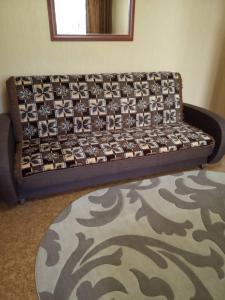a couch sitting in a living room with a rug at Апартаменты с двумя спальнями на закрытой территории in Izmail