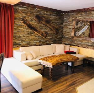 a living room with a couch and a table at Pamporovo Villa in Pamporovo