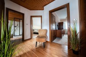 a living room with a chair and a bedroom at Ferienhaus "La Casa" in Caldaro