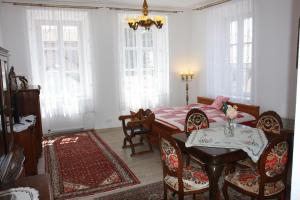 a living room with a table and a dining room at Apartmány PAPÍK in Nová Bystřice